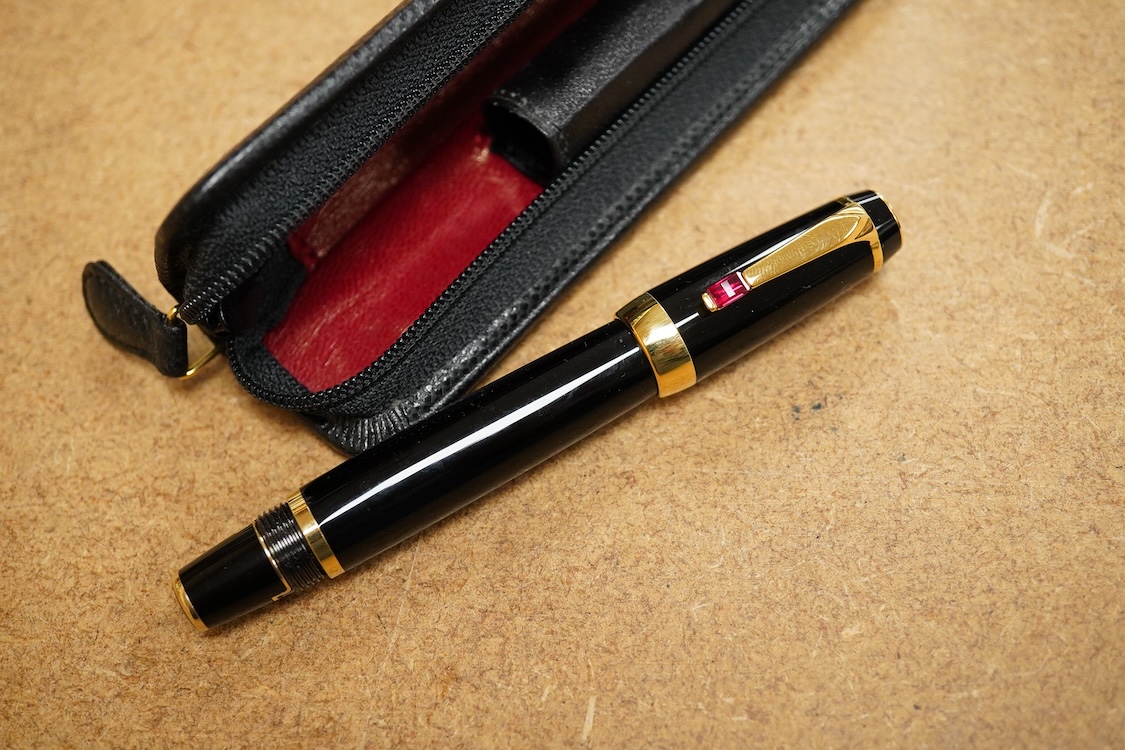 A leather cased Mont Blanc pen with retractable nib and decorative jewelled clip, 11cm long